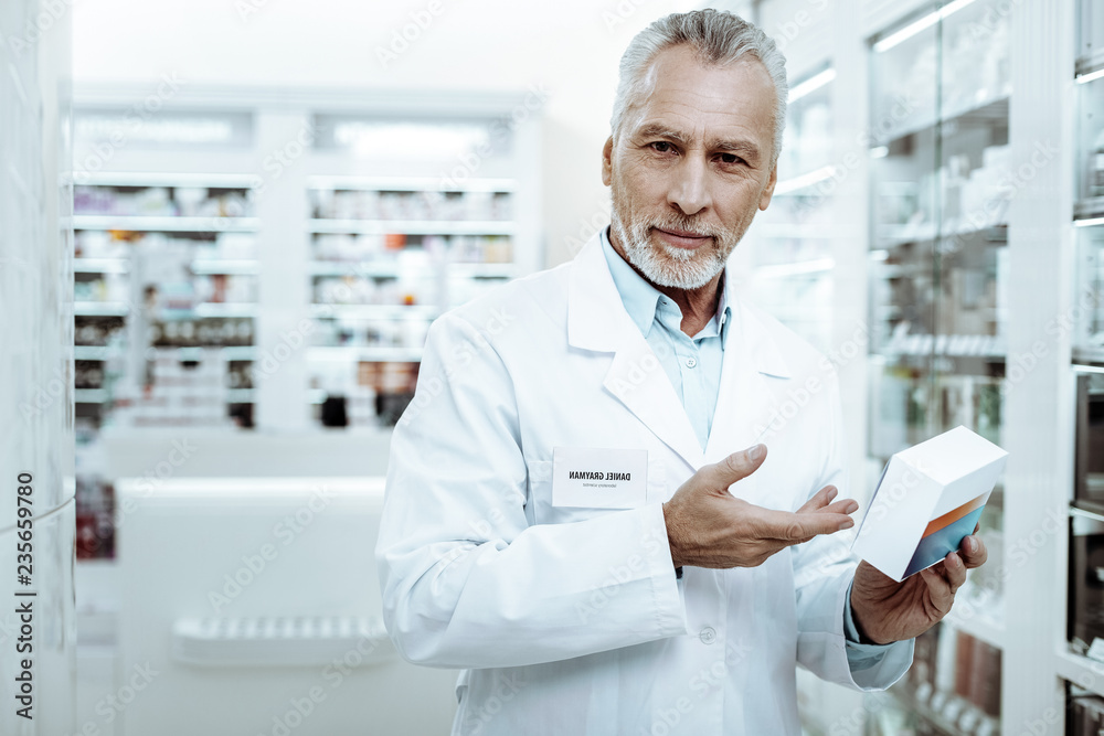 Kind senior man pointing at new tablets Kind senior man pointing at new tablets