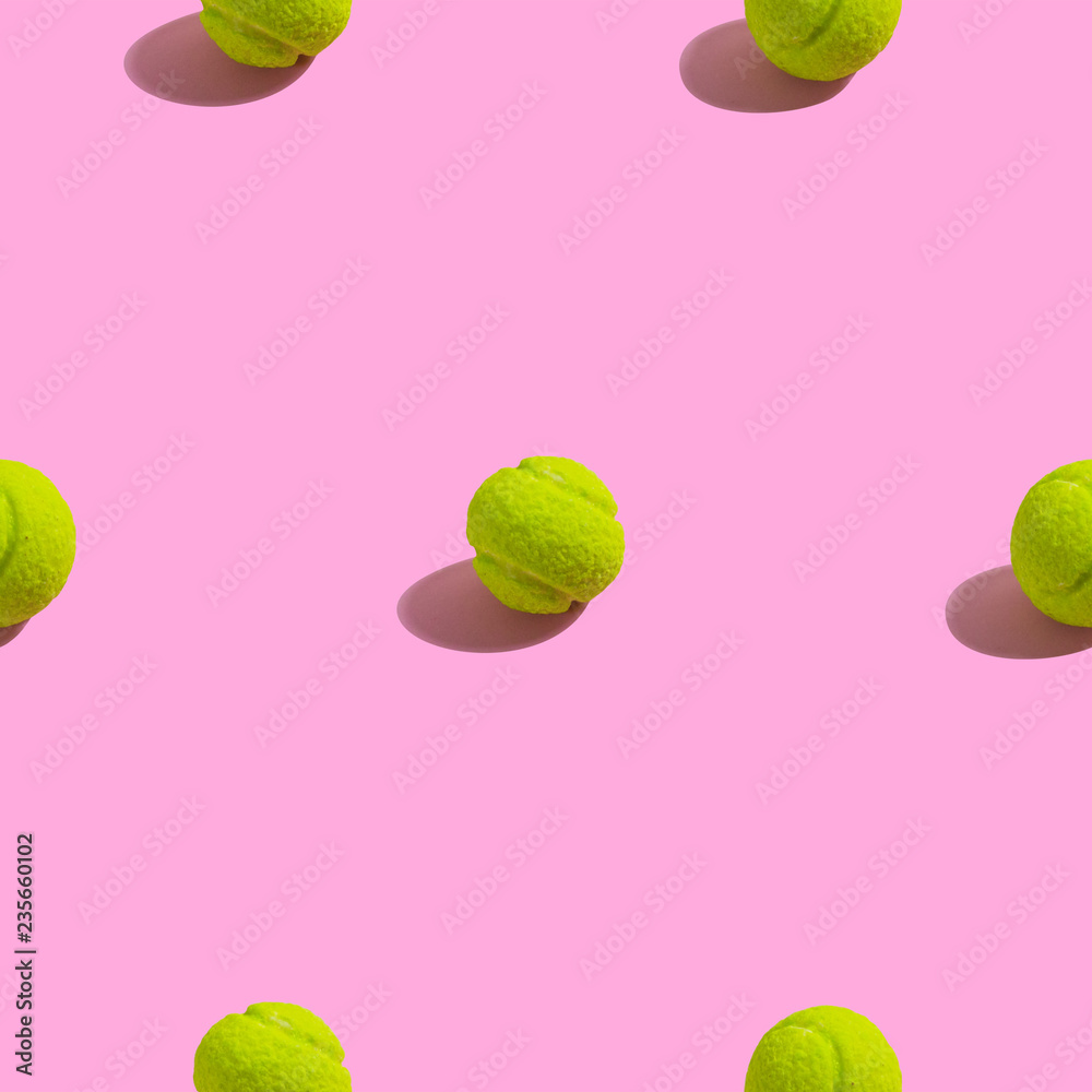Creative seamless pattern with green tennis ball on pink background. Sweet tennis abstract background