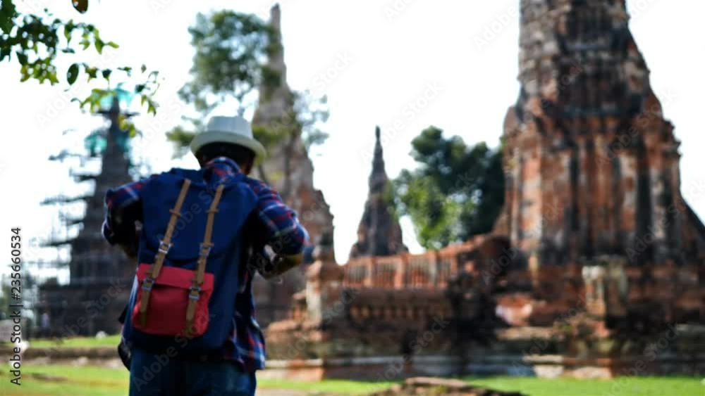 Senior man Asian with backpack are walking at Wat Chaiwatthanaram. Ancient and historical attractions and one of the most important archaeology of Ayutthaya province thailand. Travel, Tourist Concept Senior man Asian with backpack are walking at Wat Chaiwatthanaram. Ancient and historical attractions and one of the most important archaeology of Ayutthaya province thailand. Travel, Tourist Concept