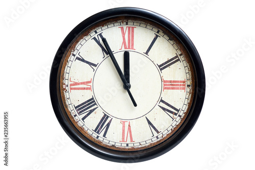 Old style classic clock with roman numbers showing almost twelve o' clock. Time almost gone or came,  isolated on white background, front view