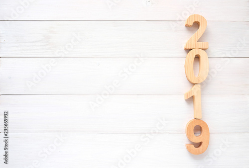 2019 wood letters on white wood background with copy space for text, 2019 new year greeting card banner