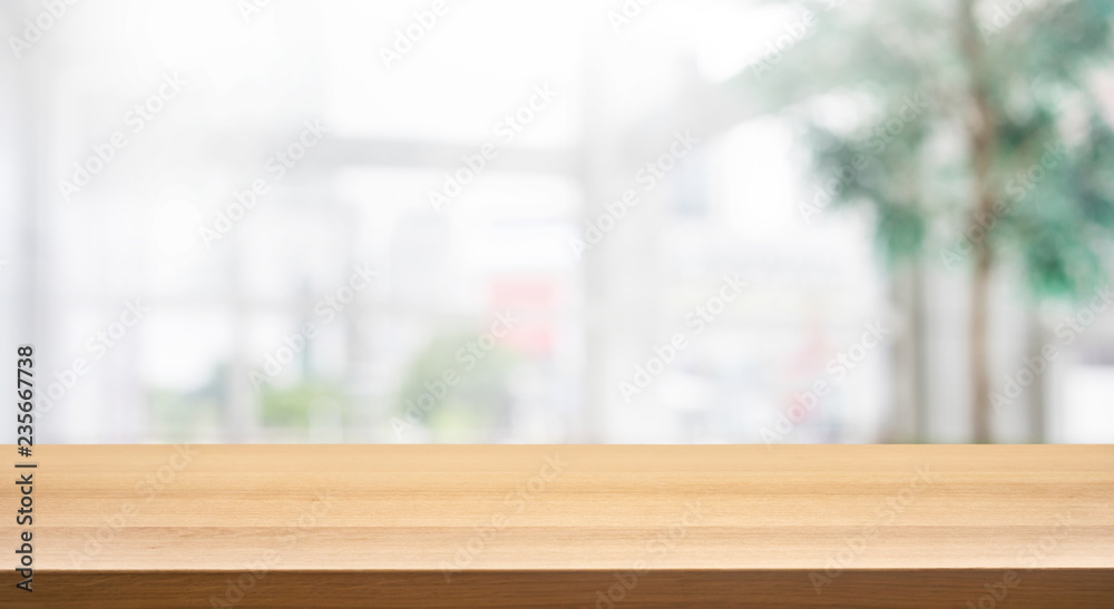 Wood table top on blur white glass wall background form office building.For  montage product display and design key visual Stock Photo | Adobe Stock
