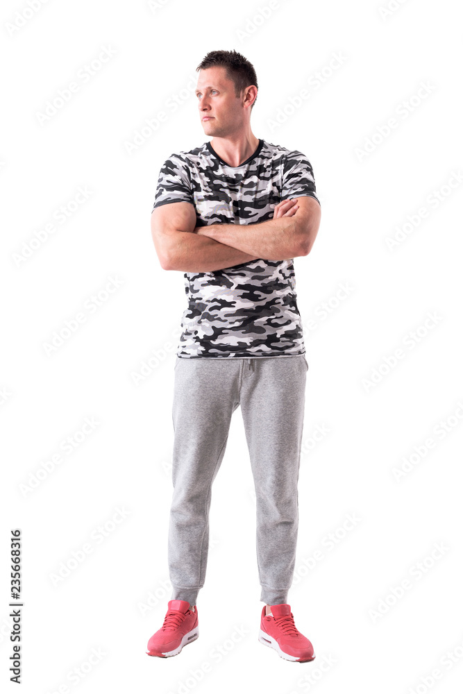 Manly confident athletic young adult with crossed arms looking away. Full body isolated on white background. Manly confident athletic young adult with crossed arms looking away. Full body isolated on white background.
