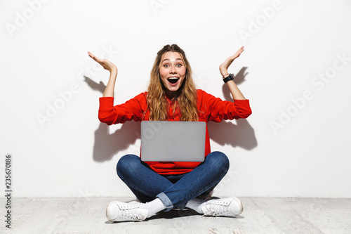 Portrait of an excited young woman wearing hoodie