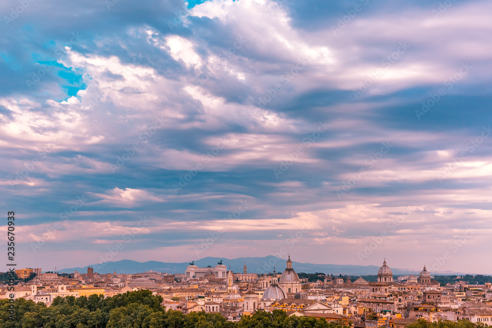 Panoramic aerial wonderful view of Rome with Altar of the Fatherland and churches at sunset time in Rome, Italy