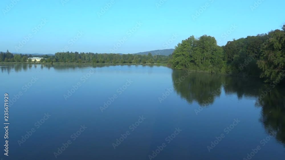 Velka Podvinice Lake is economic and agricultural pond for breeding carp fish, mainly carp and tench, quality water care and shoreline, beautiful blue water in morning with forests, Czech , Europe Velka Podvinice Lake is economic and agricultural pond for breeding carp fish, mainly carp and tench, quality water care and shoreline, beautiful blue water in morning with forests, Czech , Europe