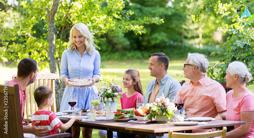 leisure  holidays and people concept - happy family having festive dinner or summer garden party