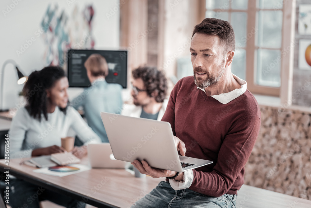 Attentive office worker staring at his gadget Attentive office worker staring at his gadget