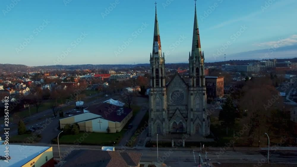Aerial shot flying through the crumbling towers of an abandoned church in an urban city neighborhood Aerial shot flying through the crumbling towers of an abandoned church in an urban city neighborhood