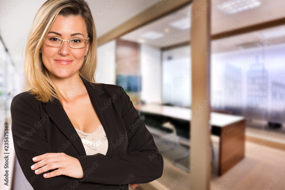 Brazilian business woman looking at camera in blurry office background. Copy space. Brazilian business woman looking at camera in blurry office background. Copy space.