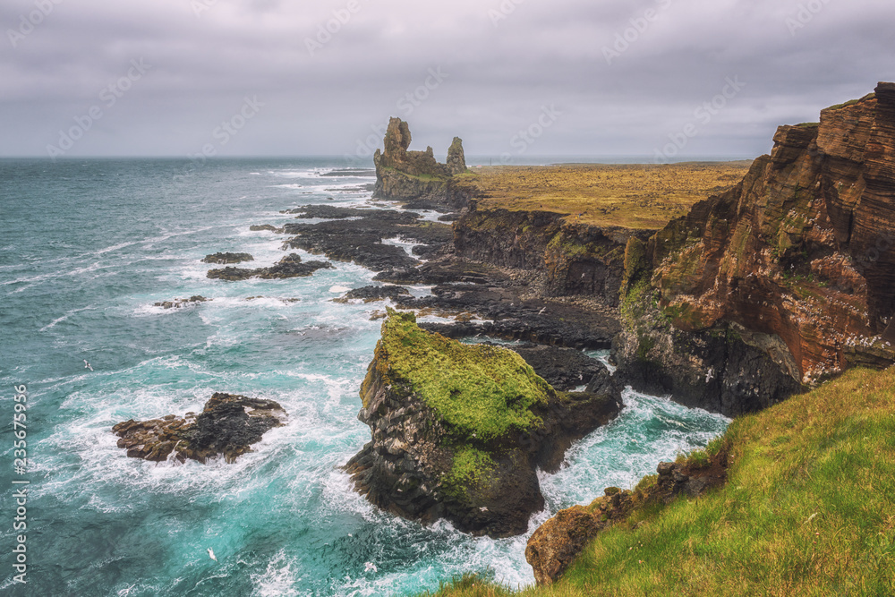 Amazing seascape, basalt rocks at the volcanic cliff, view from popular viewpoint, Atlantic coast of Arnarstapi in the west of Iceland, natural travel background. Snaefellsnes peninsula, Iceland