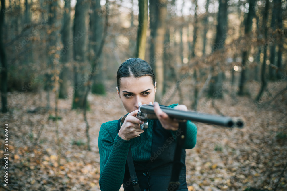Hunter woman with shotgun on hunt. Hunting in forest. Portrait of woman Hunter. Closed and open hunting season. Autumn hunting season. Hunting. Hunter woman with shotgun on hunt. Hunting in forest. Portrait of woman Hunter. Closed and open hunting season. Autumn hunting season. Hunting.