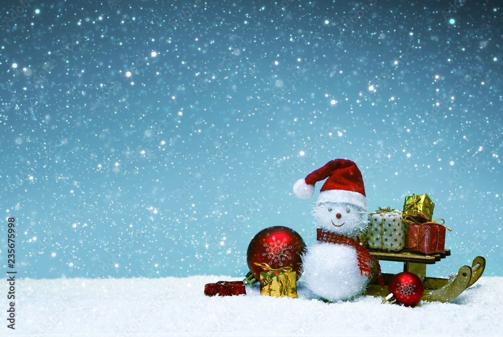 Christmas snowman with gifts on the sledge and snowfall. Christmas snowman with gifts on the sledge and snowfall.