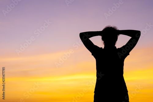 Young woman relaxing with sunset