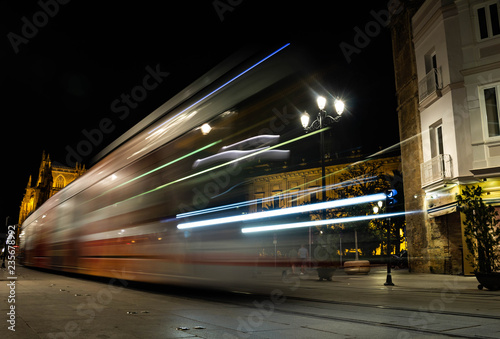 A city train moving during the night. photo