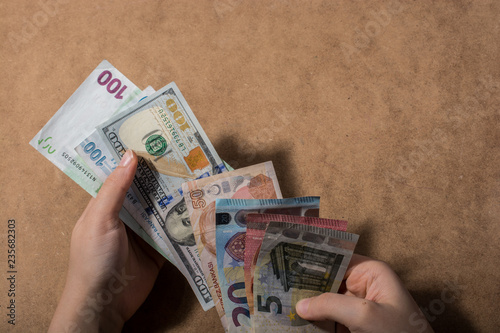 Hand holding American dollar  isolated on wooden background photo