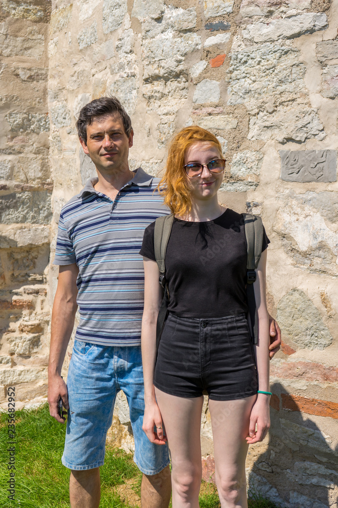 Handsome middle-aged man and young pretty lady in sunglasses sta Handsome middle-aged man and young pretty lady in sunglasses sta