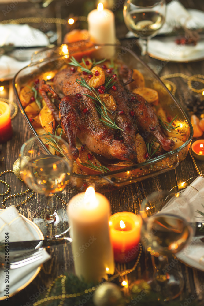 Roast duck. Thanksgiving table served with turkey, decorated with rosemary and pomegranate seeds and candles. Roast duck, table. Christmas dinner, Flat lay