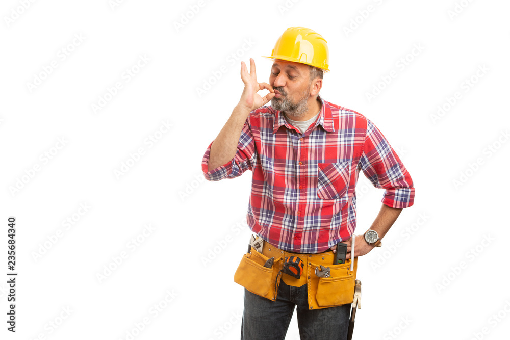 Builder kissing tip of fingers.