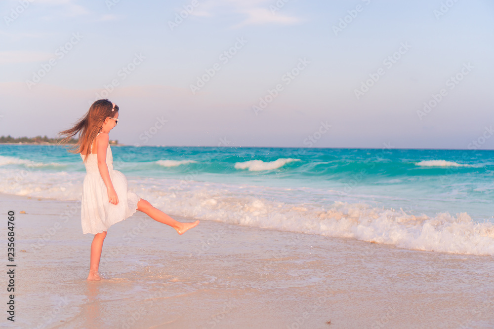 Adorable happy little girl have fun on beach vacation Adorable happy little girl have fun on beach vacation