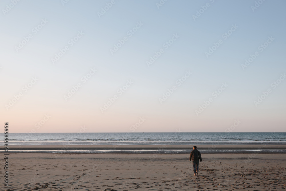 man walking on the beach, north sea