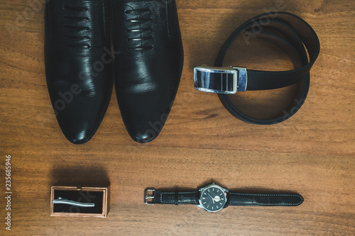 Men's accessories: watch, tie, belt, shoes top view