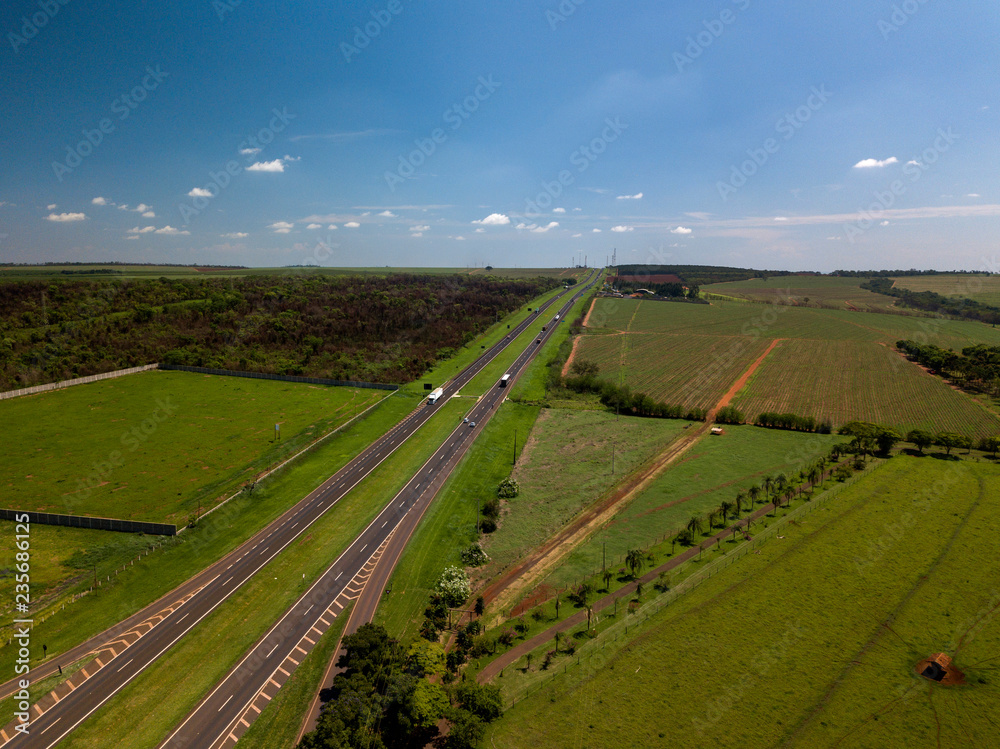 Aerial view of the straight road along sugar cane field in Sao Paulo State, Brazil.