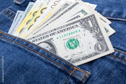 Dollar and Euro paper currency in denim jeans pocket
