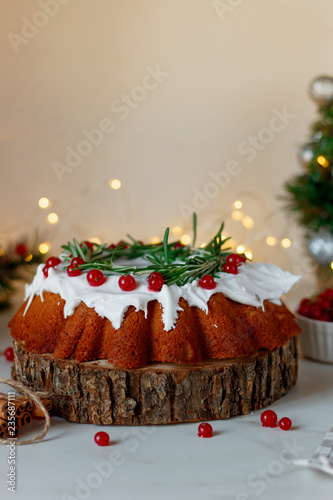 Christmas fruit cake, pudding on wooden saw.