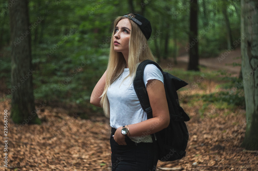 Traveling woman with backpack and peaked cap. Forest Gdansk. Traveling woman with backpack and peaked cap. Forest Gdansk.