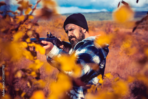 Autumn hunting season. Hunter with shotgun gun on hunt. Autumn.