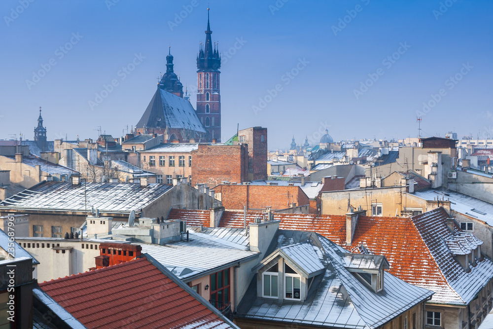 Krakow in Christmas time, aerial view on snowy roofs in central part of city. St. Mary's Basilica on Main Square. Poland. Europe.