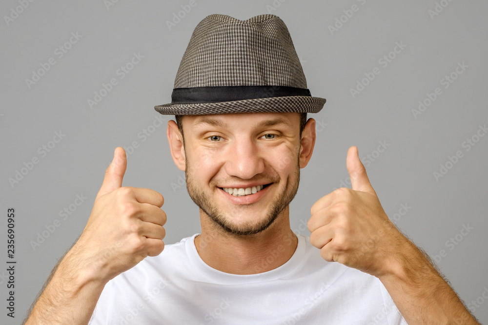 Portrait of man smiling and showing two thumbs up Portrait of man smiling and showing two thumbs up