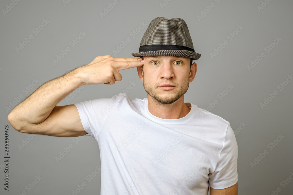 Young man makes suicide gesture and going to kill himself Young man makes suicide gesture and going to kill himself