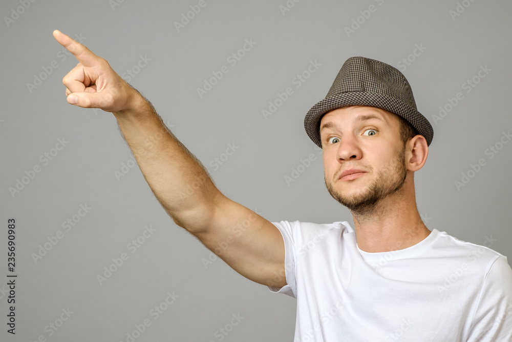 Portrait of suspicious man pointing left with hand Portrait of suspicious man pointing left with hand