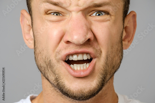 Portrait of angry screaming young man