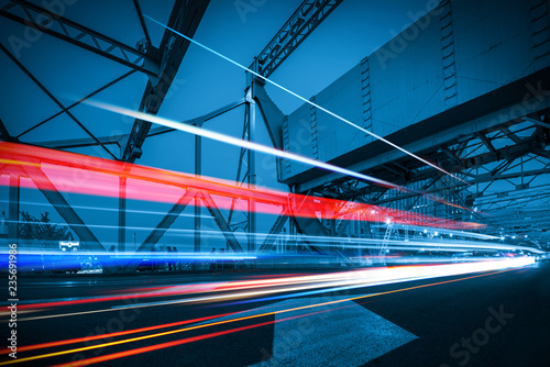 Photography abstract image of blur motion of cars on the city road at night，Modern urban arc