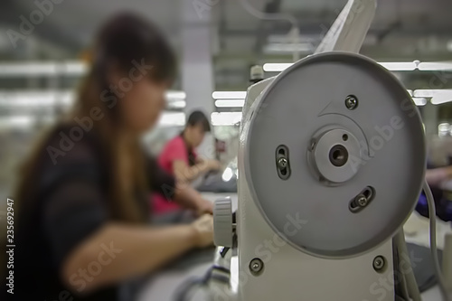 Abstract, blur, bokeh background, defocusing - image for the background. People work in the clothing industry.