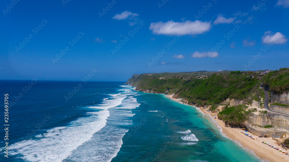 Beach on aerial drone top view with ocean waves 