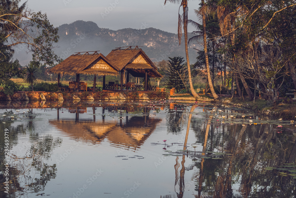 Obraz premium Two gazebos near the pond with mountain view in Luang Prabang, Laos