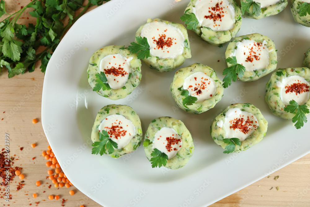 Potato balls with chive, parsley, and spices serving with fresh yogurt Potato balls with chive, parsley, and spices serving with fresh yogurt