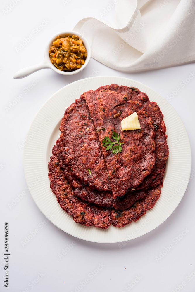 Ragi Roti made from finger millet from India is extremely rich in proteins served with pickle or achar. selective focus