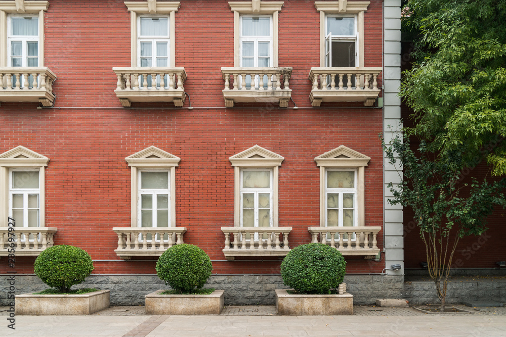 The facade of the old house. The Windows and decoration of walls The facade of the old house. The Windows and decoration of walls