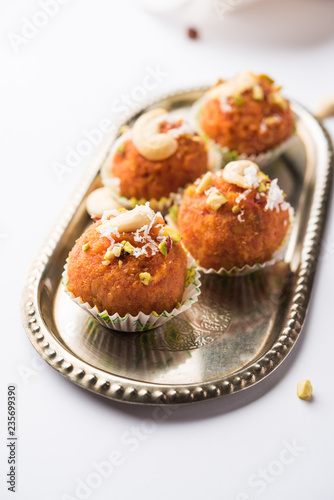 Carrot Halwa Laddu or sweet balls, served in a plate with dry fruits toppings. selective focus