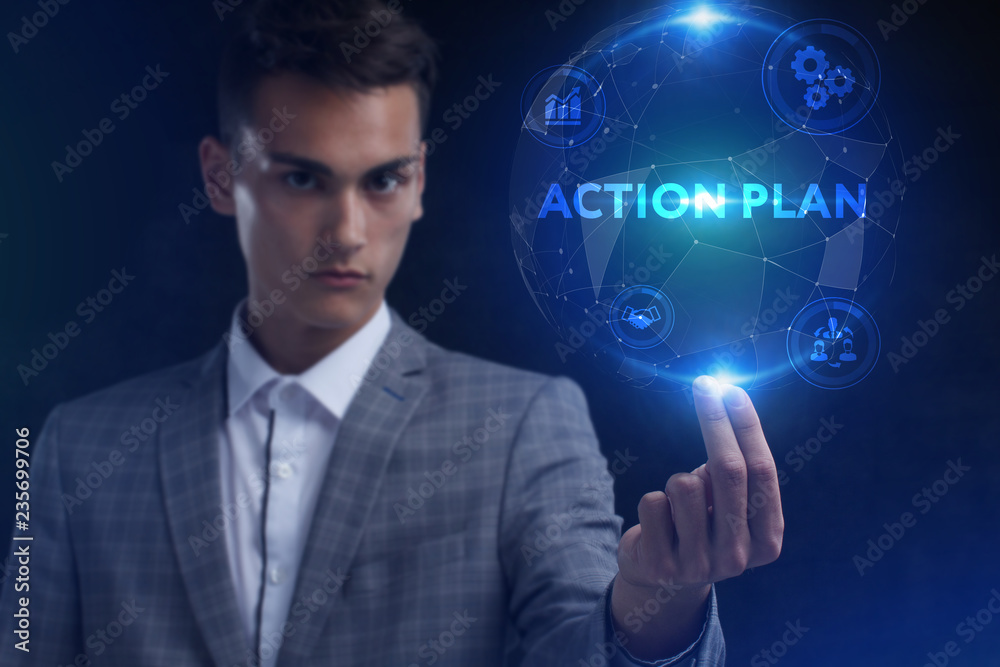 The concept of business, technology, the Internet and the network. A young entrepreneur working on a virtual screen of the future and sees the inscription: action plan The concept of business, technology, the Internet and the network. A young entrepreneur working on a virtual screen of the future and sees the inscription: action plan