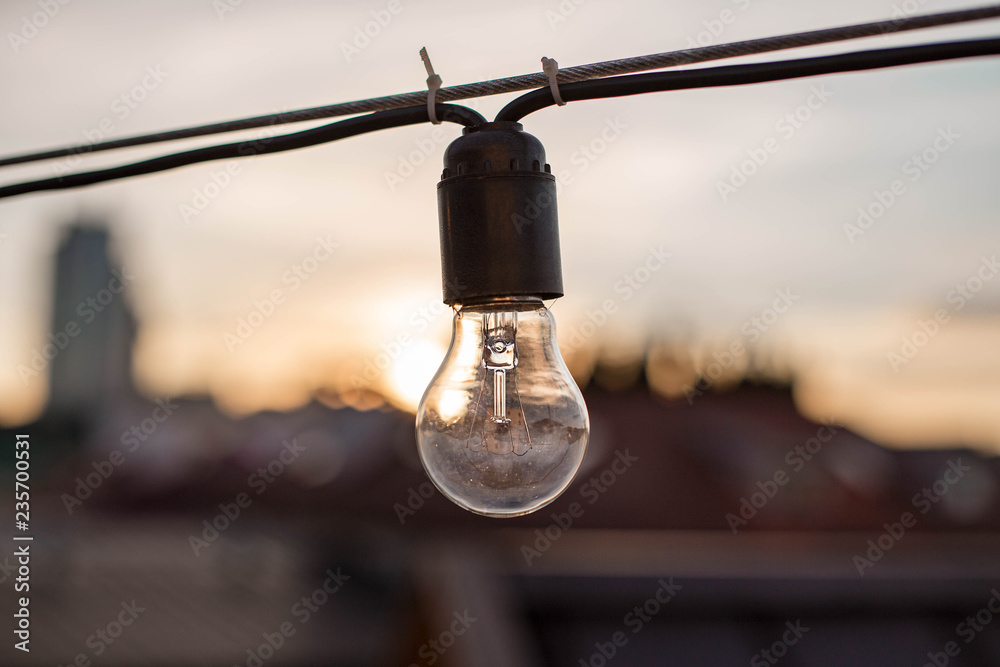 Obraz premium Vintage beautiful lamps on the street at sunset. City decoration. Chain of lamps on the wire. Belarus, Minsk.