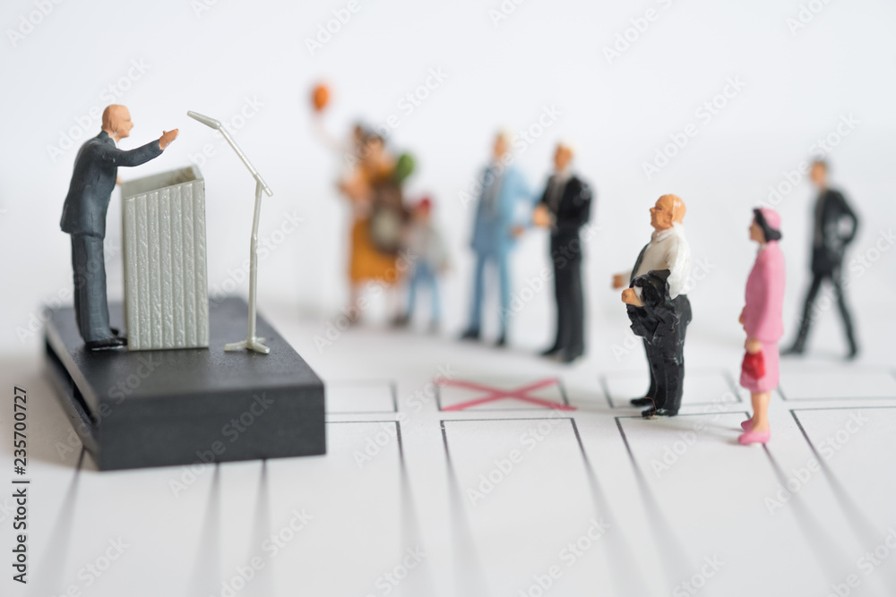 Miniature people : politician or party candidate in excited speech persuades Miniature people : politician or party candidate in excited speech persuades