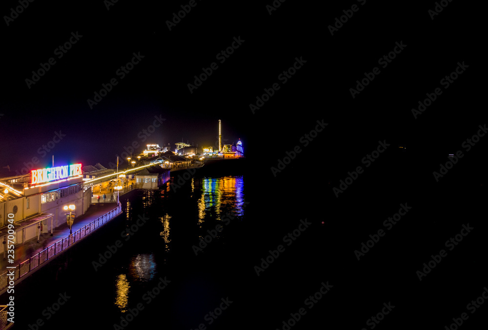 Brighton Pier from above side view, Drone shot of Pier at night, beach front amusement arcade