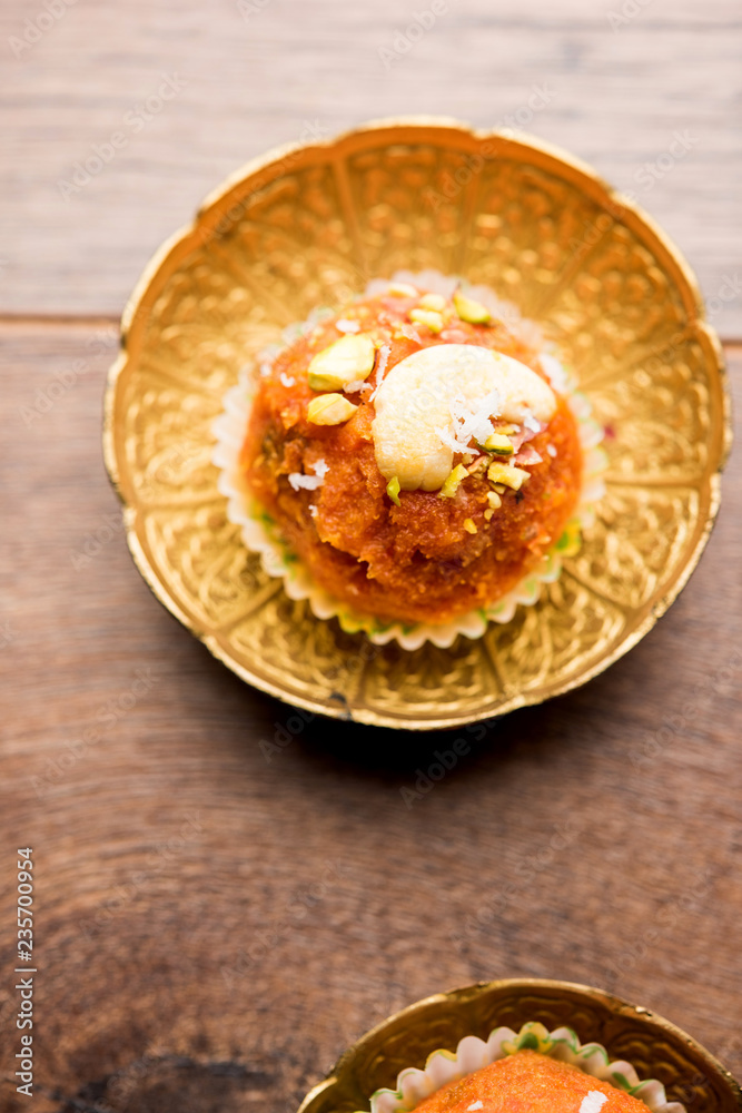 Carrot Halwa Laddu or sweet balls, served in a plate with dry fruits toppings. selective focus Carrot Halwa Laddu or sweet balls, served in a plate with dry fruits toppings. selective focus