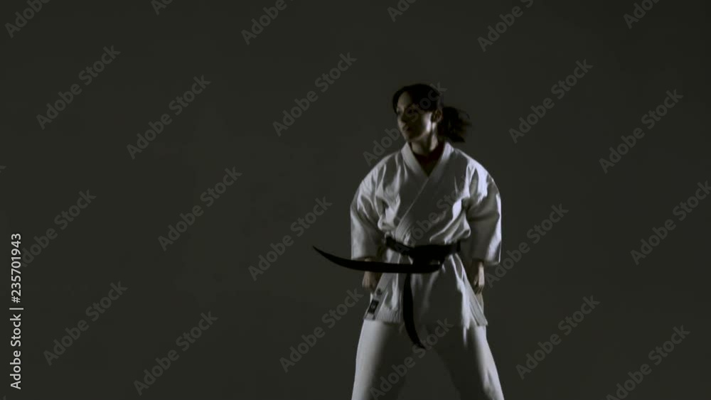karate girl practicing multiple jump kicks, wearing kimono, on dark background. slow motion recorded at 120fps
karate girl practicing multiple jump kicks, wearing kimono, on dark background. slow motion recorded at 120fps